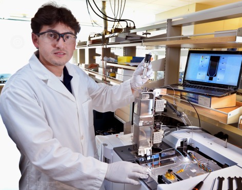 Juan Proano Aviles, an Iowa State doctoral student in mechanical engineering, uses a micropyrolyzer to simulate the thermal and chemical behavior of biomass as it’s processed into bio-oil